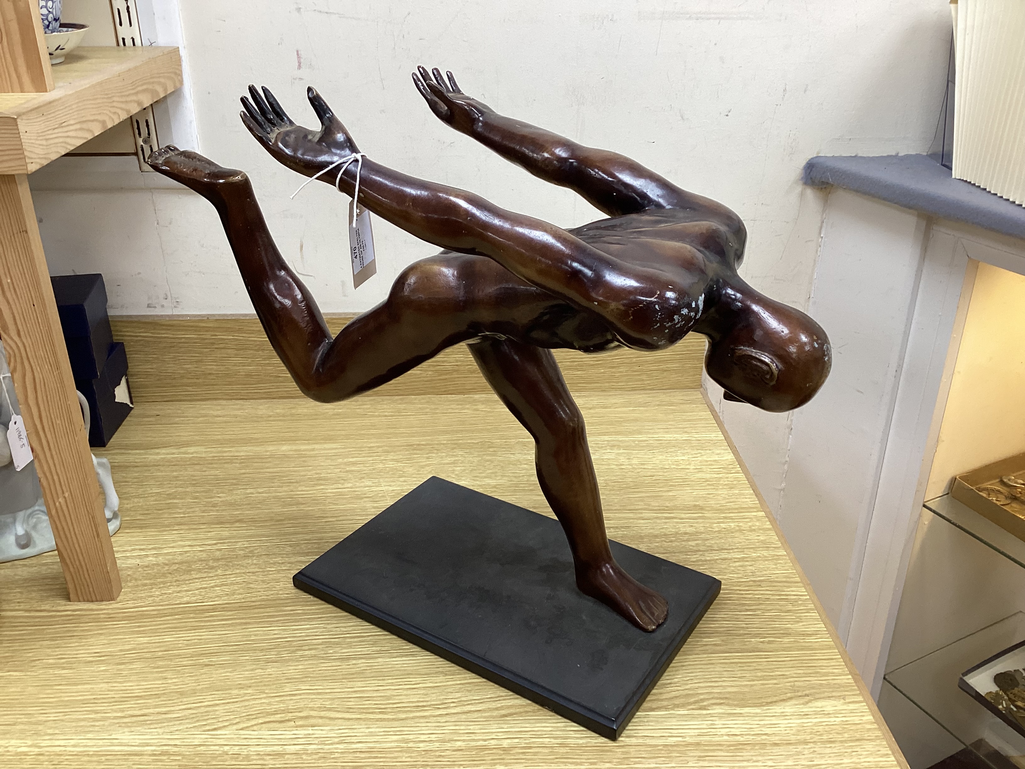 A patinated spelter figure of an Olympian figure, 62 cm wide x 52cm high